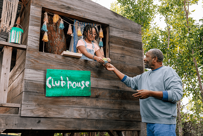 father and daughter by a tree house image