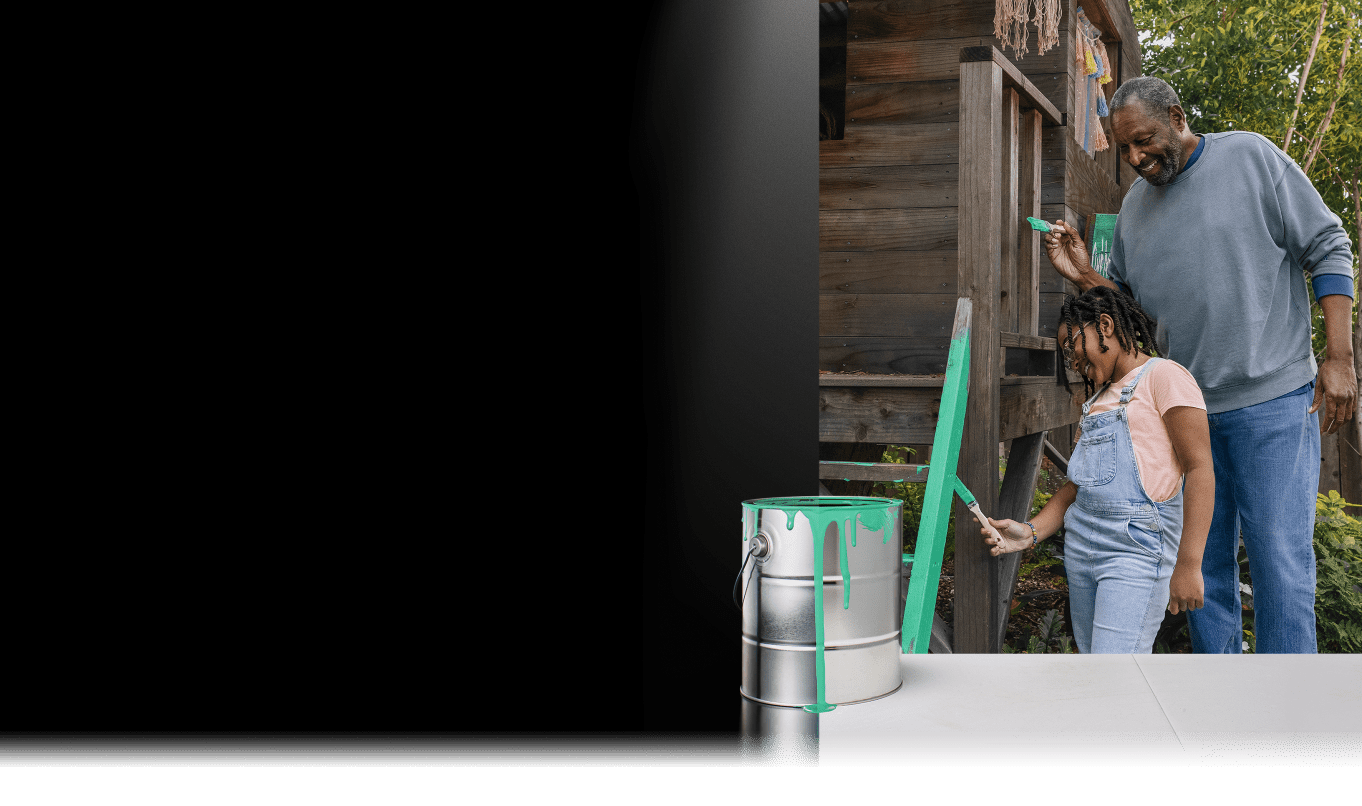 Man and girl painting an outdoor clubhouse together