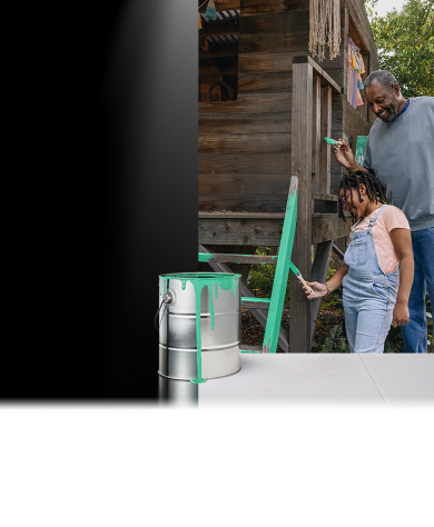 Man and girl painting an outdoor clubhouse together