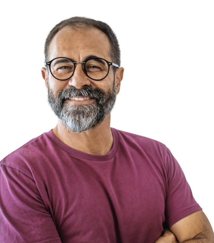 Man in maroon t-shirt with glasses and a beard smiling with his arms folded