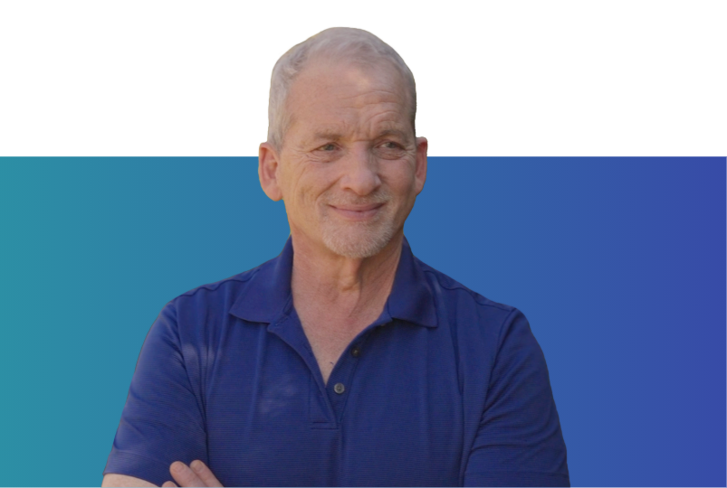 Man in blue t-shirt with arms folded staring to his left